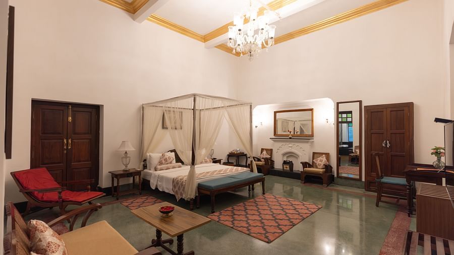 Imperial Suite at Saraca Hotel, Lucknow with a double bed placed in the centre of the room with small carpets placed around it