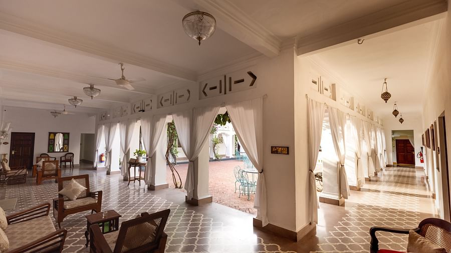 Seating arrangement in a clean, white themed interior at Saraca Hotel, Lucknow