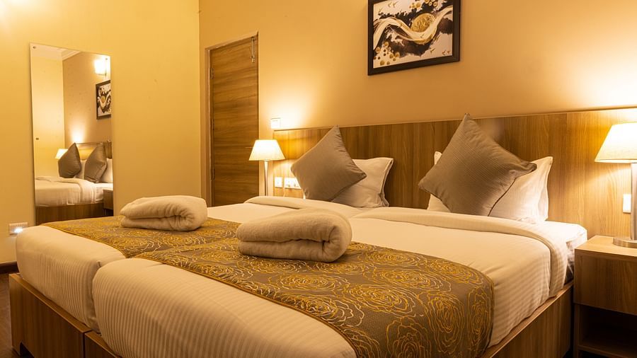 Twin beds inside the Deluxe One Bedroom Suite - Starlit Suites Tirupati