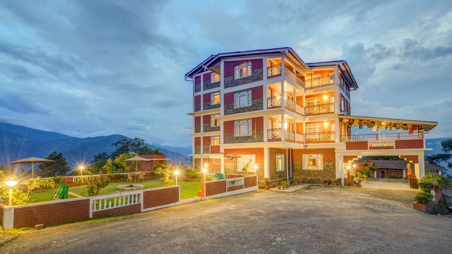 Facade of Summit Tashi Ghang Heritage Resort, Pelling with mountains in the background