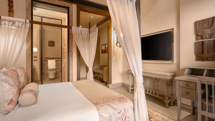 Corner view of the Premium Room featuring a double bed along with a wall mounted television in front of it at The Evren, Vagator.