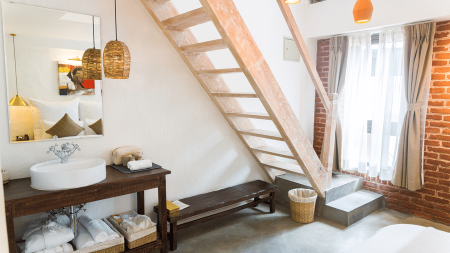 Deluxe loft room where a staircase is leading to the loft and the washroom area in the lower level - The Nanee