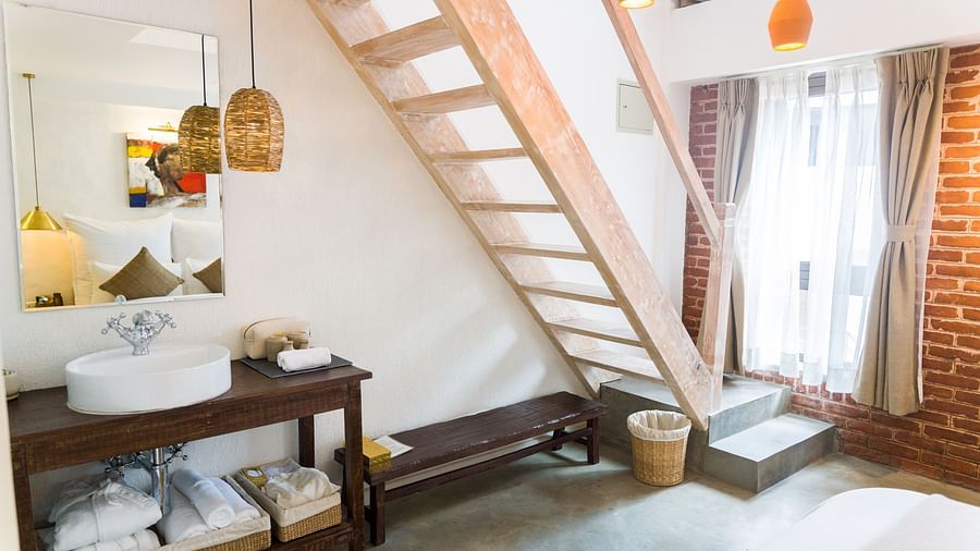 Deluxe loft room where a staircase is leading to the loft and the washroom area in the lower level - The Nanee