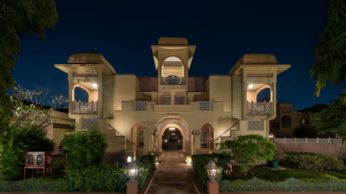 exterior facade of Heritage Village Resort & Spa, Manesar lit up at night