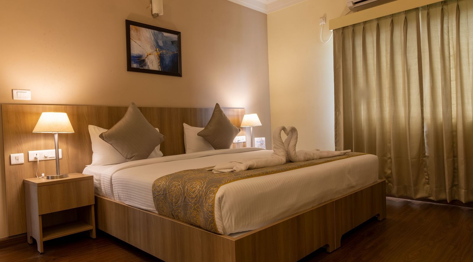 A double bed with side tables inside Deluxe Two Bedroom Suite - Starlit Suites, Tirupati