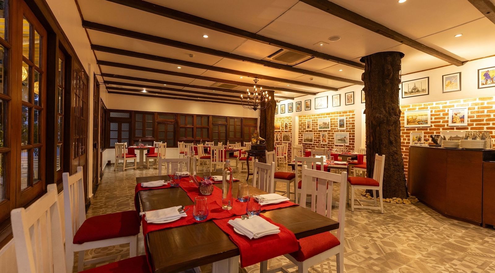 Asian Table Restaurant at Saraca Hotel, Lucknow with a red and white interior theme alongside wooden panelling on the walls and ceilings