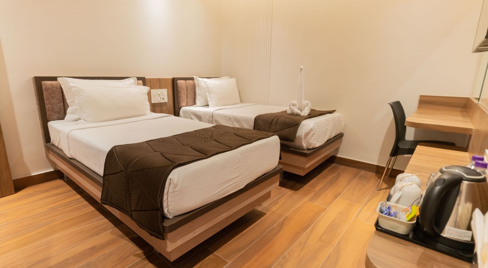 Comfortable twin beds with modern flooring and soft lighting at Beestay Hotels, Rajahmundry.