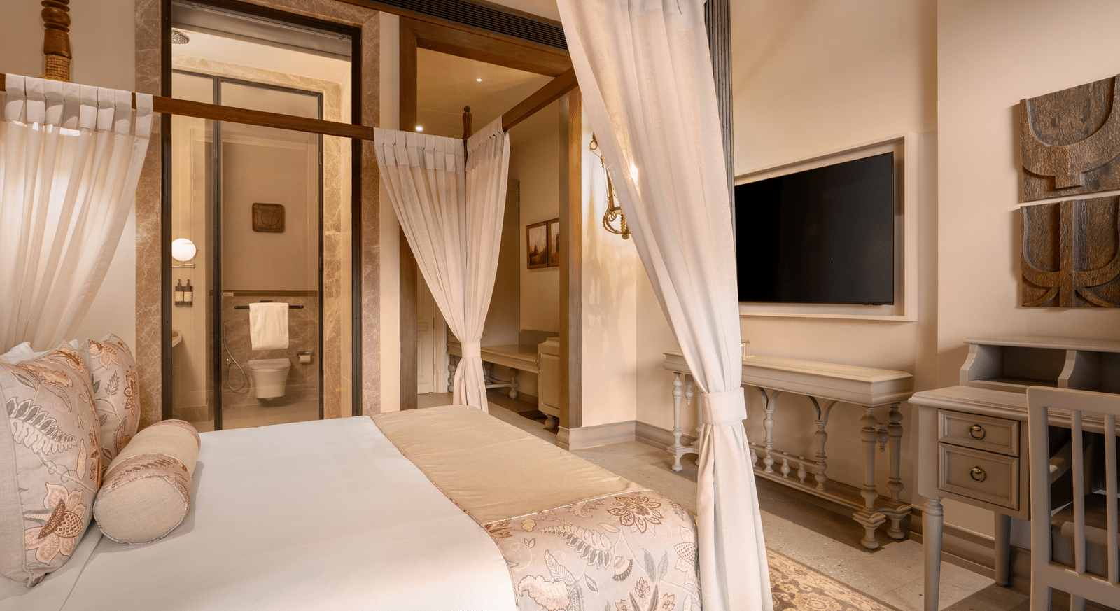 Corner view of the Premium Room featuring a double bed along with a wall mounted television in front of it at The Evren, Vagator.