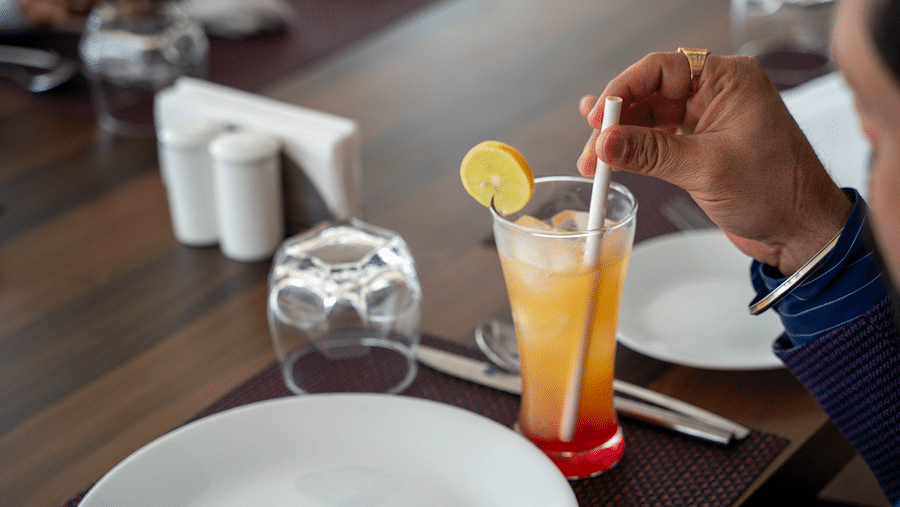 A close-up of a guest enjoying a refreshing drink - Hotel Udai Median, Udaipur.