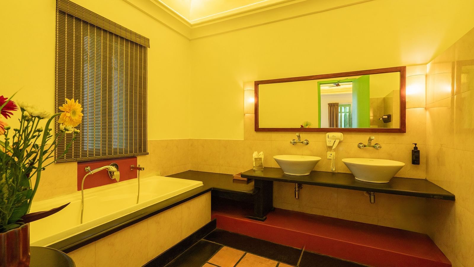 Suite Washroom with a bathtub, mirror and two wash basins.