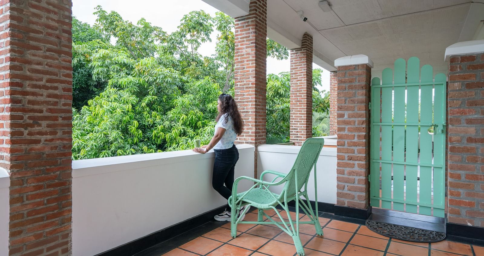 Suite Balcony  with turquoise chair and door.