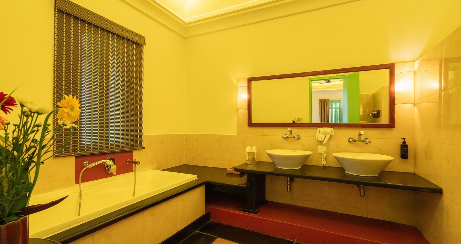Suite Washroom with a bathtub, mirror and two wash basins.