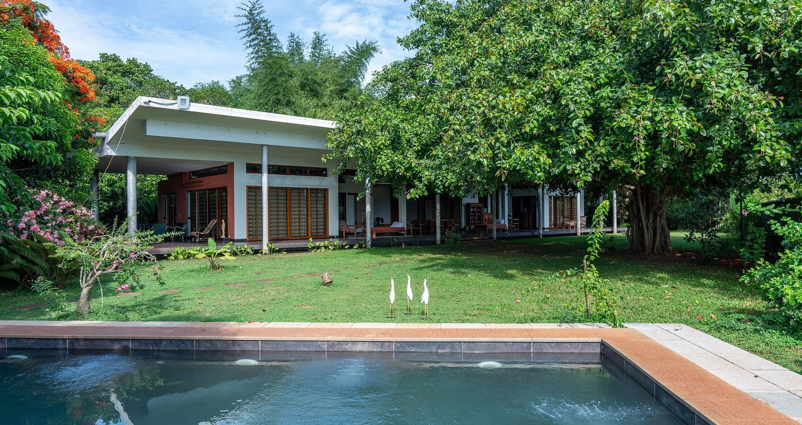 Villa Lawn- Comfortable seating in the sit-out area, overlooking the private pool and garden.