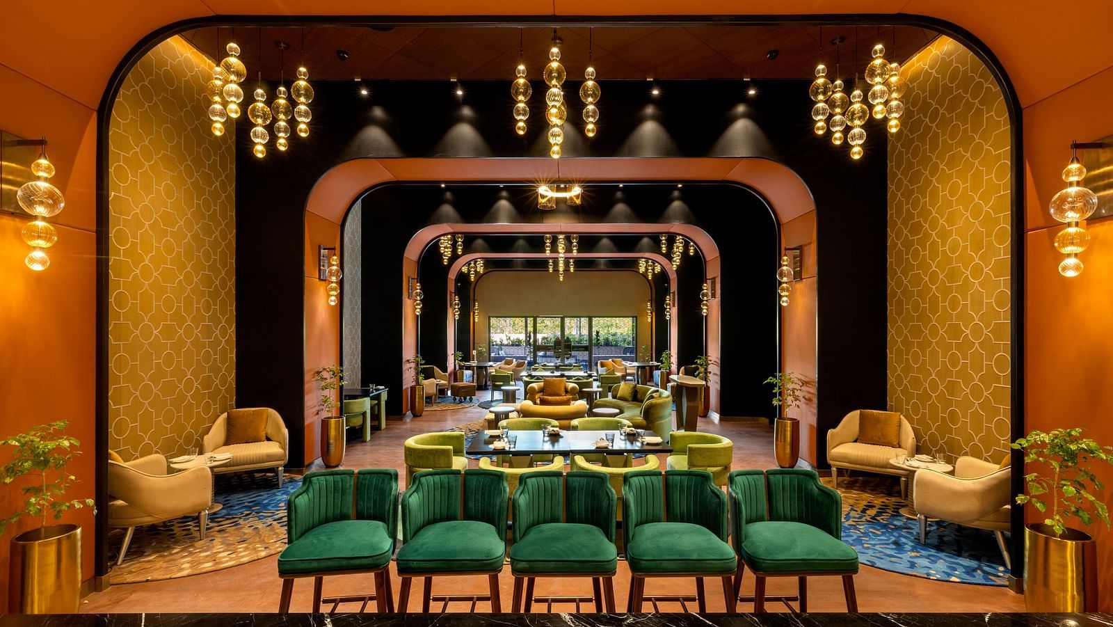 Luxurious dining space in Madurai with golden accents and sophisticated decor with multiple seating arrangement - Grand Madurai by GRT Hotels
