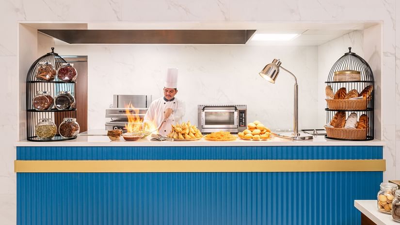 A live interactive counter at our restaurant in Haridwar where the chef is preparing food - MJ Sarovar Portico, Haridwar