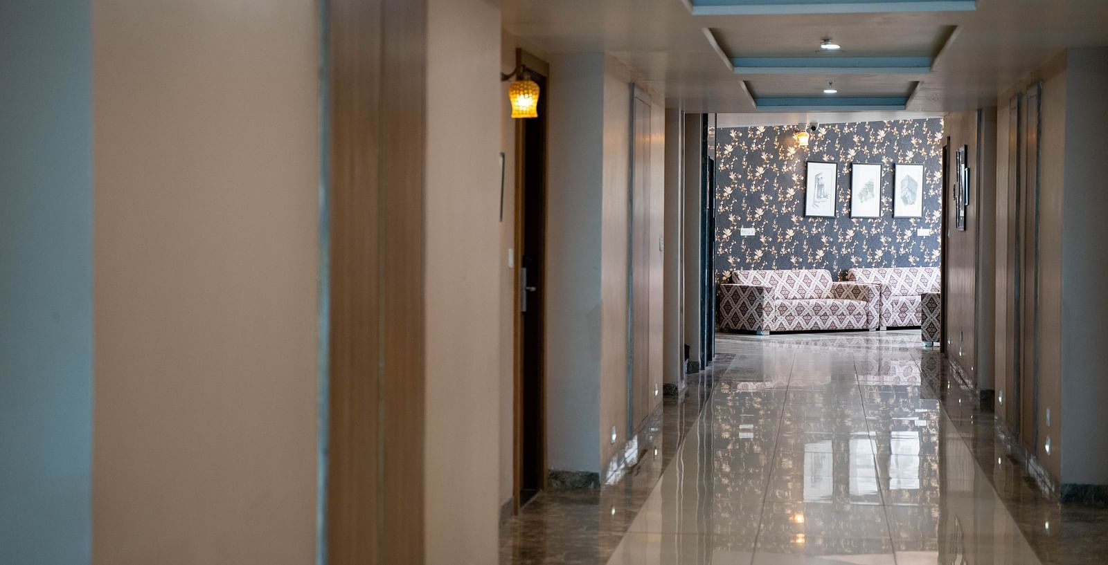 Hallway with multiple doorways leading to lobby of Bamboo Saa Mulberry Resort designed with Rajasthani elements.