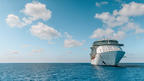 a blue white ship sailing through the ocean during daytime