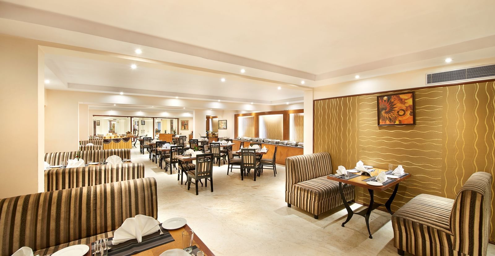 Interiors of a well-lit restaurant at Accord Highland Ooty
