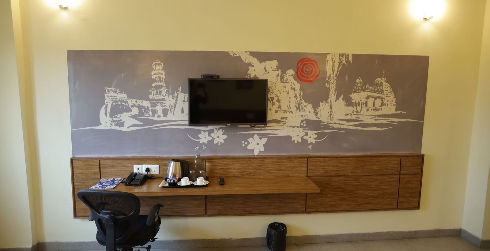 a wall mounted television along with a work desk and an office chair in a room - Max Hotel Jabalpur