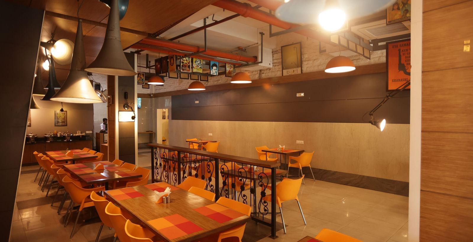 full view image of the dining area with cosy interiors and warm lighting - Max Hotel, Jabalpur