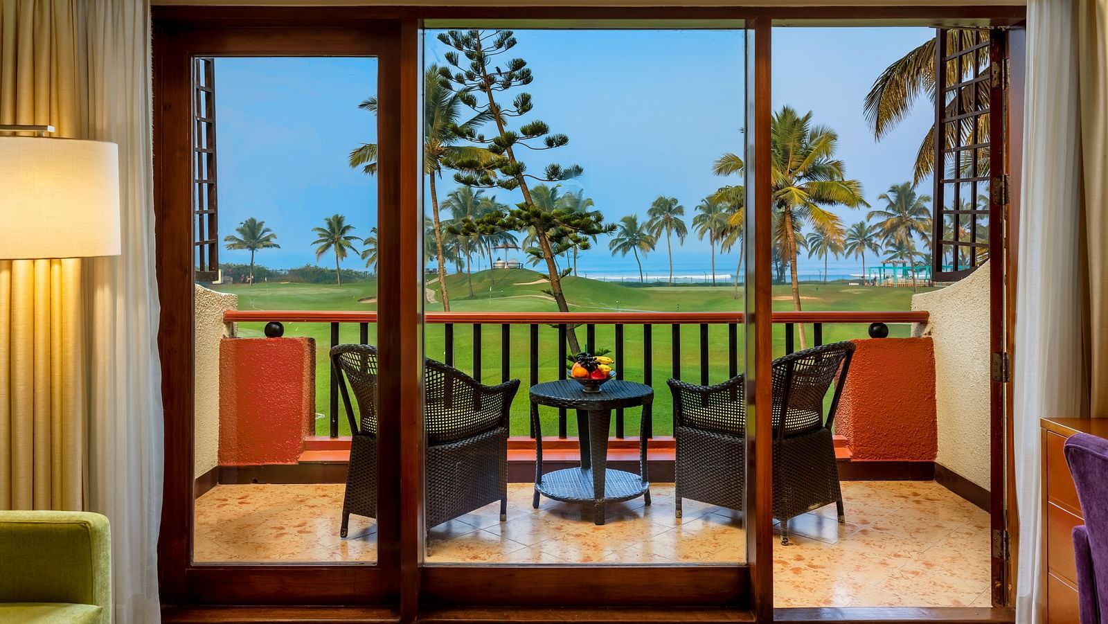 two chairs and a table in the balcony of Ocean front view - Caravela Beach Resort Goa