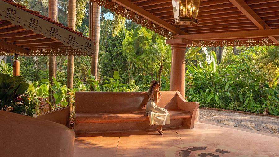 Cosy wooden outdoor seating area with a swing and natural surroundings.