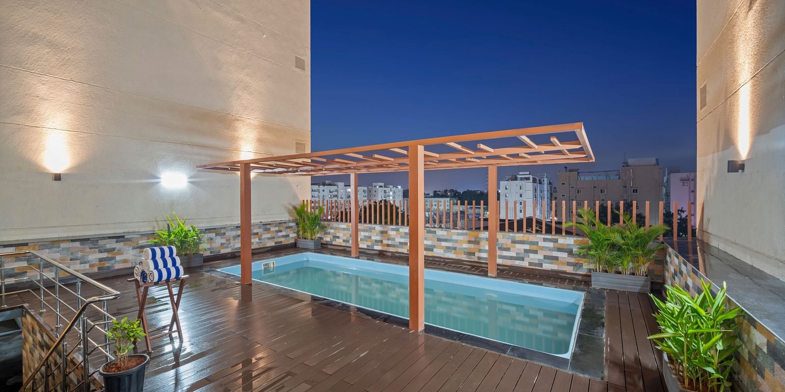 An image of a swimming pool at night of Grand Vijayawada by GRT Hotels.