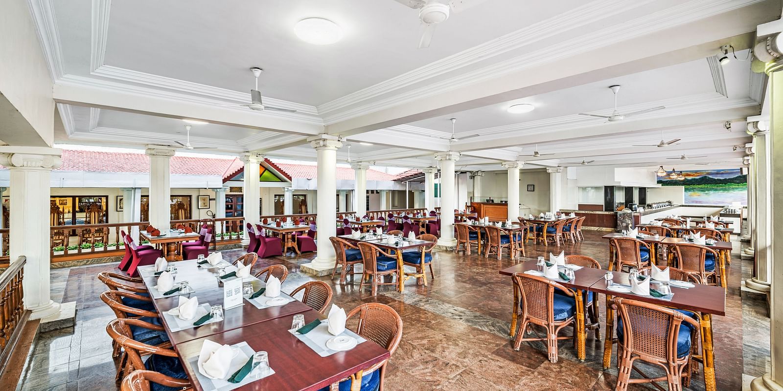 An image of the outdoor dining area featuring tables and chair at GReaT Trails River View Resort Thanjavur By GRT Hotels