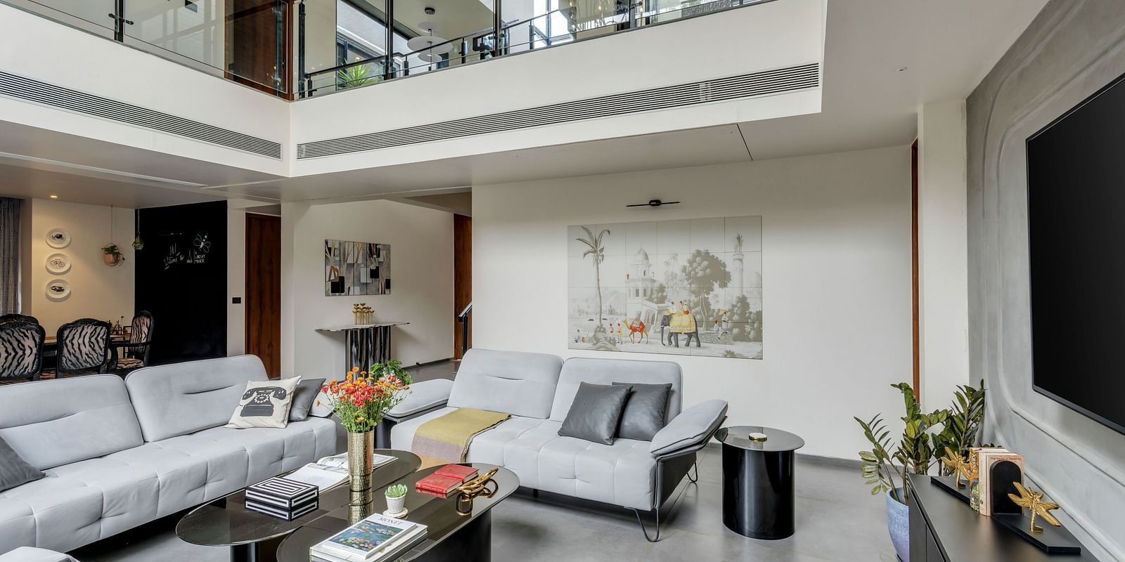  Close-up view of the living area at Lindsay Manor, featuring a sofa, LCD TV, tea table, and a flower pot on top.