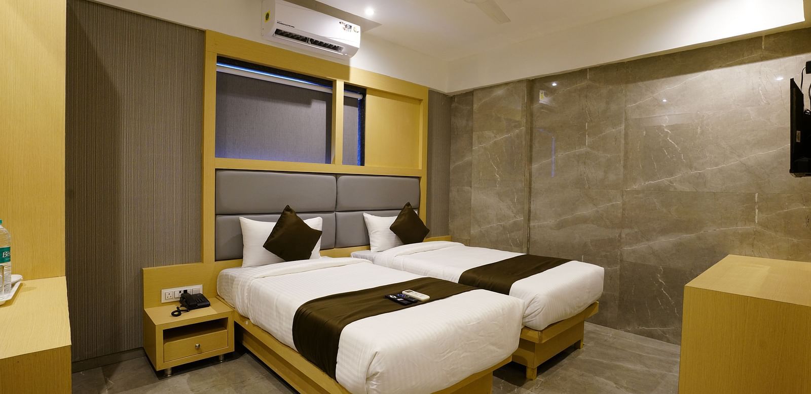 Hotel room with two single beds, bedside tables, and wall shelves - Shyanu Lords Eco Inn Airoli