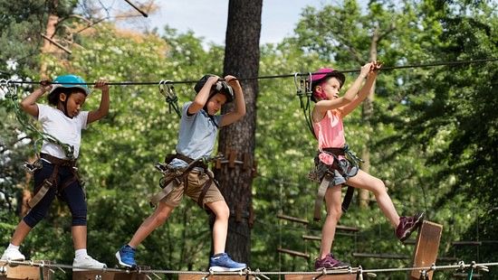 Kids walking on the zipline and having fun