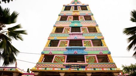 An image of the Manimandapam surrounded by greenery