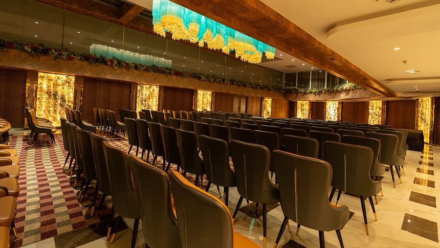 an image of an event hall filled with chairs with yellow illuminating lights at Clarks Inn Suites Hyderabad