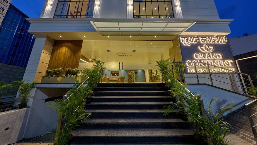 A facade image of the hotel with an illuminated signboard indicating the name of the hotel
