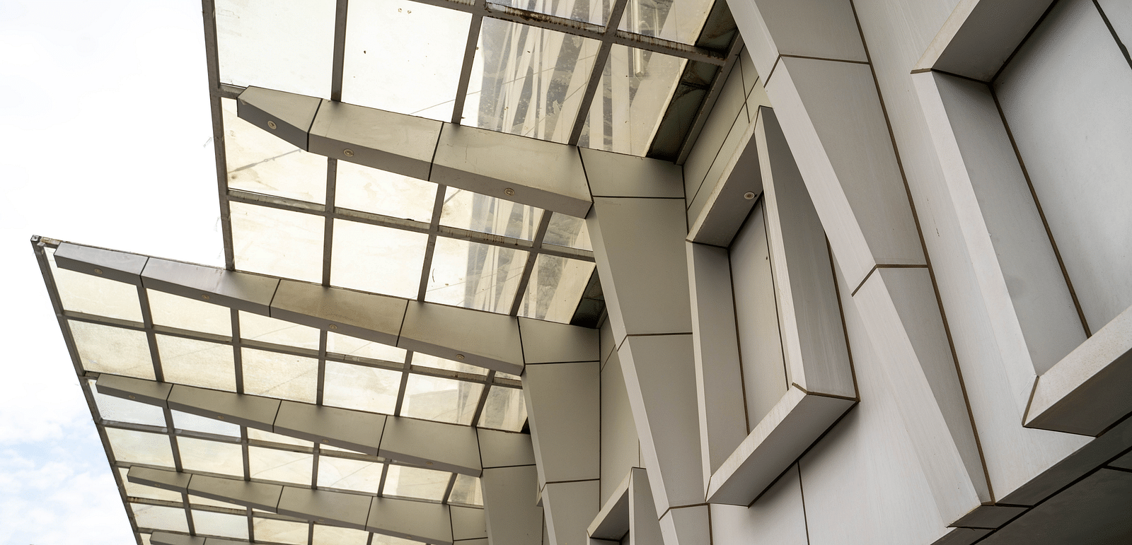 Modern architectural exterior of a building featuring sleek lines and glass panels - Hotel Udai Median, Udaipur.