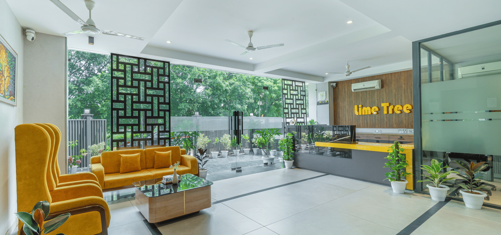 Lobby area featuring cosy chairs and contemporary interiors at Lime Tree Hotel & Stays Greater Noida Nearby India Expo Centre & Mart.