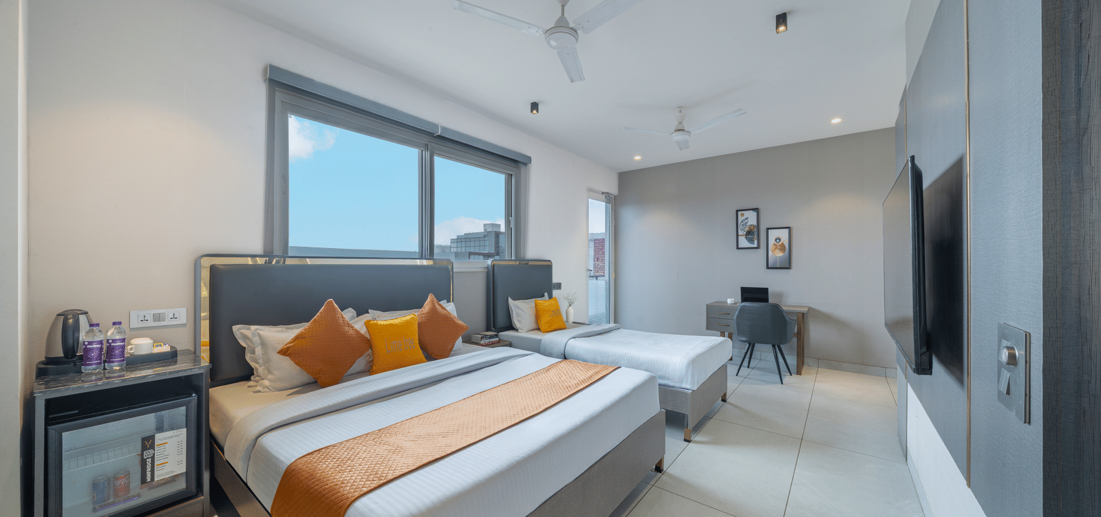 Bright guest room with modern decor and comfortable bedding at Lime Tree Hotel & Stays Greater Noida Nearby India Expo Centre & Mart.