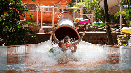 An image of the Aquadrenaline Vortex at Water Kingdom where a man is sliding down into the water