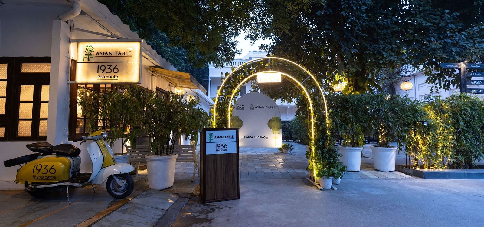 Entrance to Asian Table at Saraca Hotel, Lucknow with a lot of greenery surrounding it