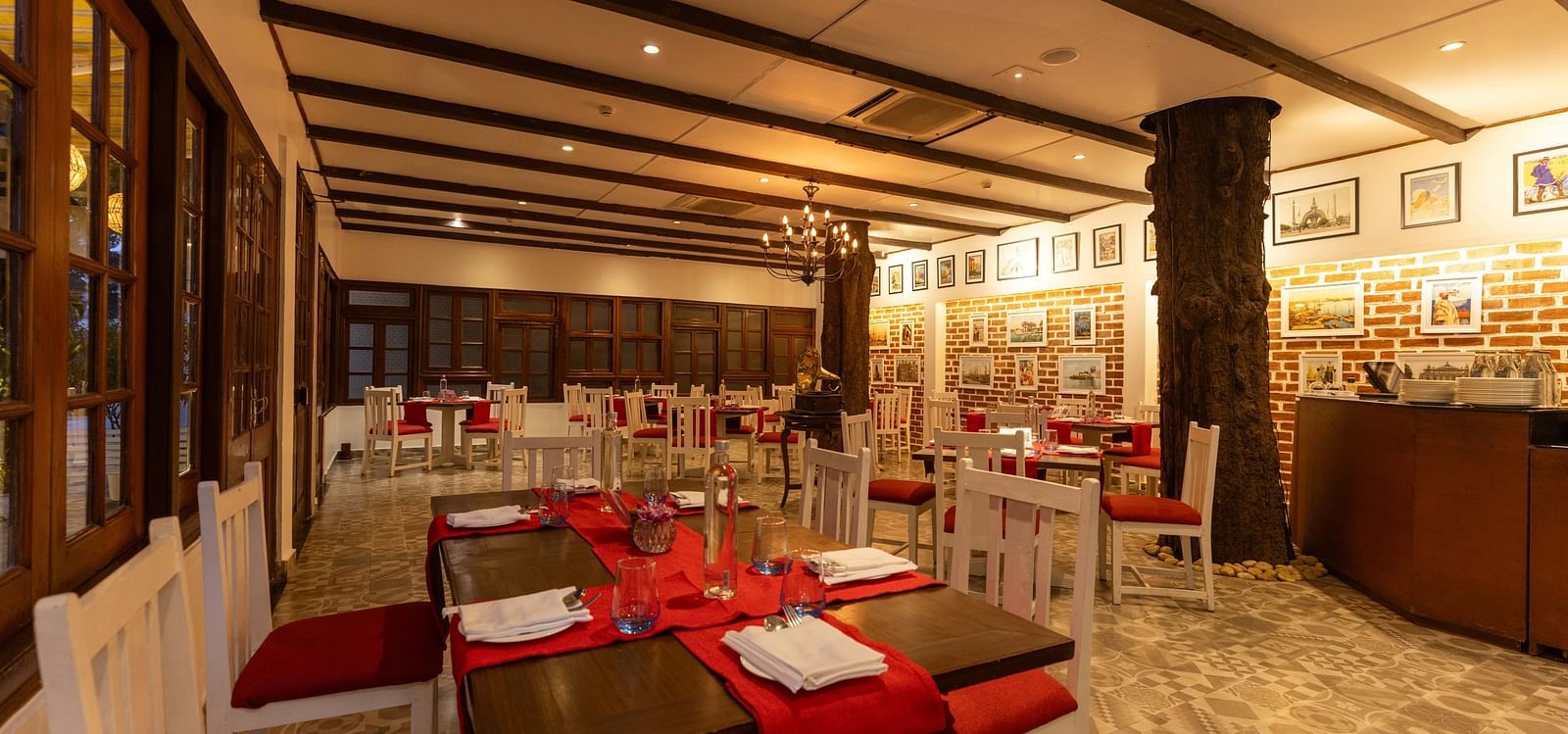 Asian Table Restaurant at Saraca Hotel, Lucknow with a red and white interior theme alongside wooden panelling on the walls and ceilings