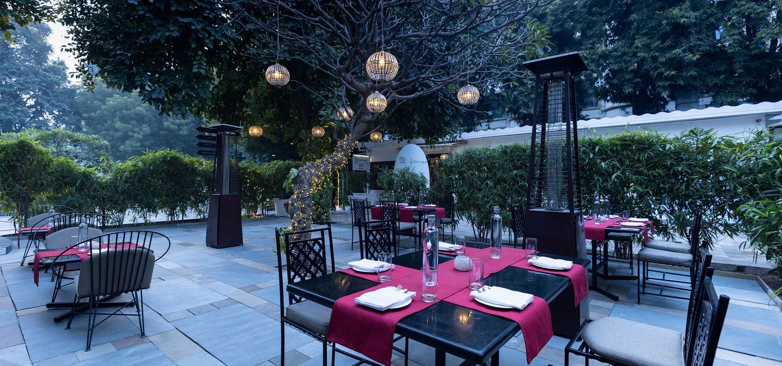Asian Table at Saraca Hotel, Lucknow with a dining set up in the outdoor patio area