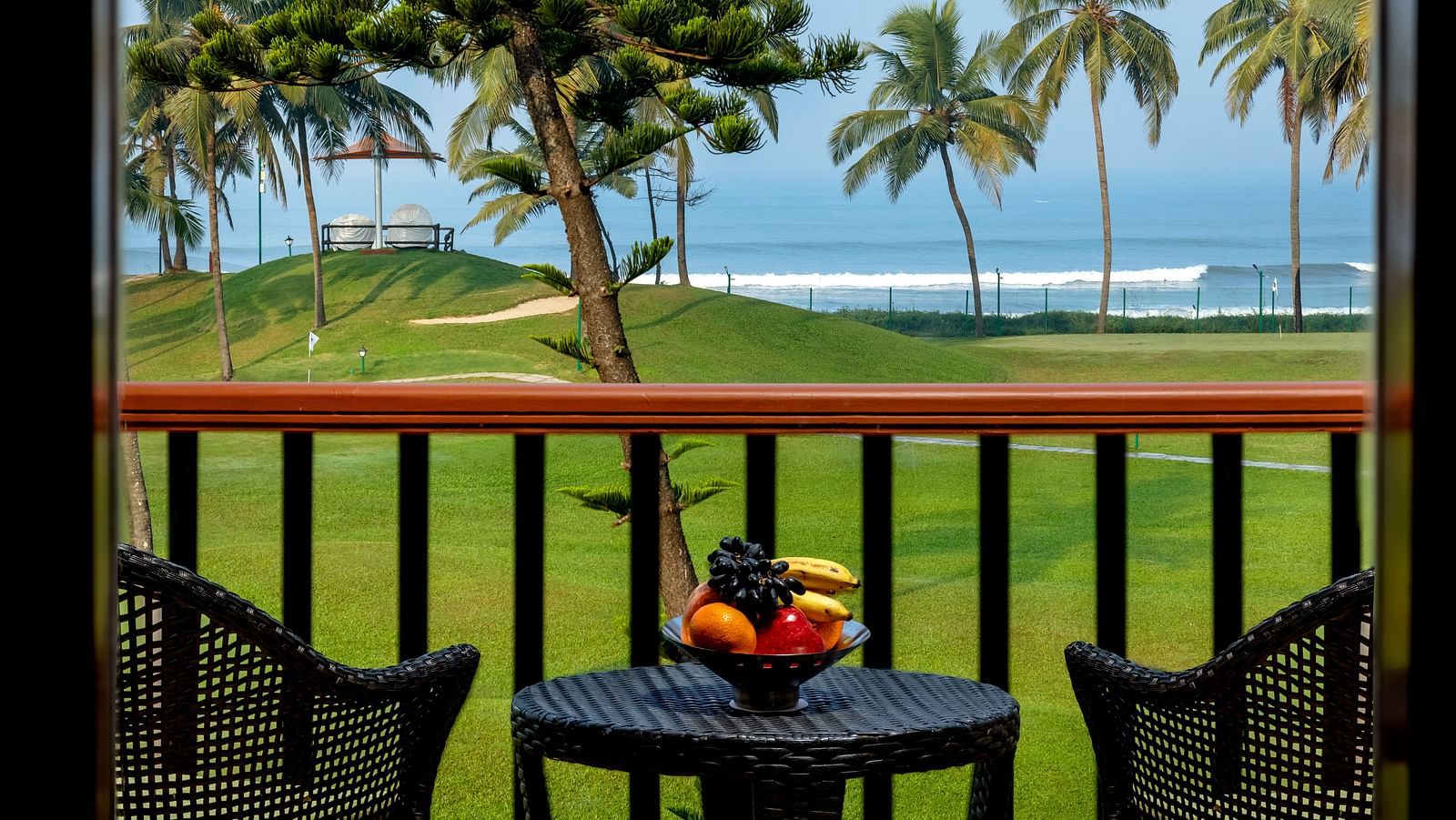 two chairs and a table in the balcony of Ocean front view - Caravela Beach Resort Goa