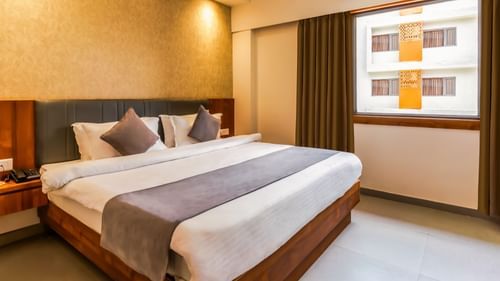 view of a king size bed of a room at Pride Elite Becharaji