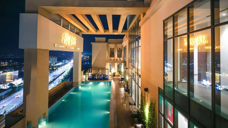 an image of a rooftop swimming pool with city views
