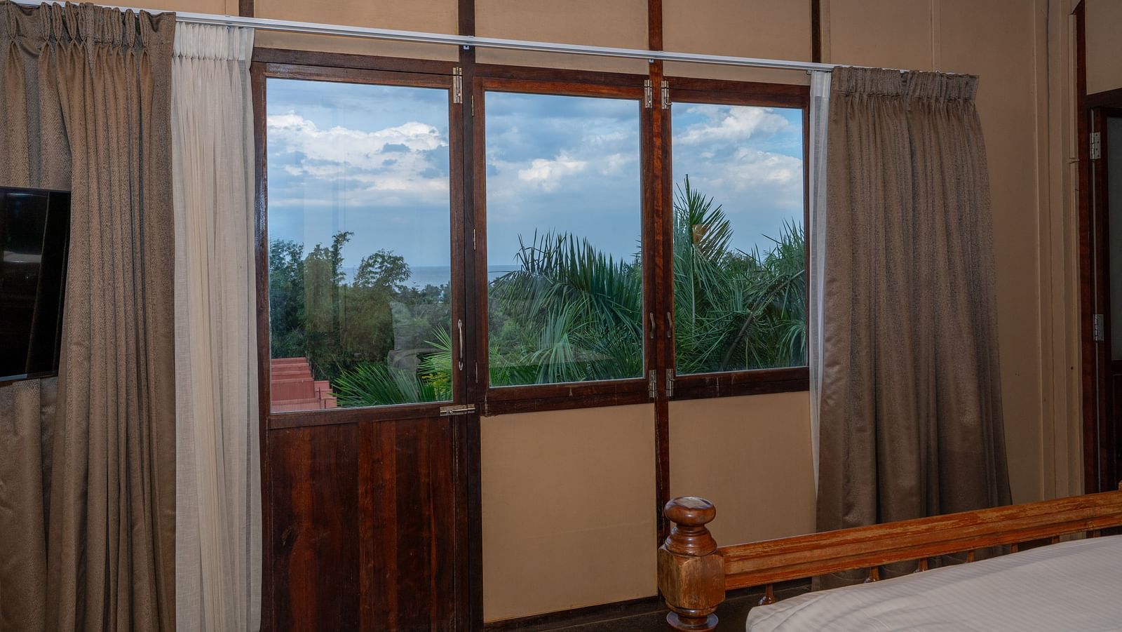 Superior Bedroom  balcony view with curtains.