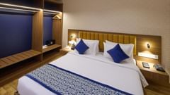 A spacious hotel room in Bengaluru with a king size bed and accent lighting - Grand Continent, Brookefield