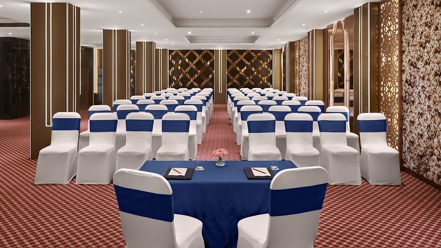An image of the banquet hall with chairs placed towards the table of the speaker - Deventure Sarovar Portico, Patel Nagar