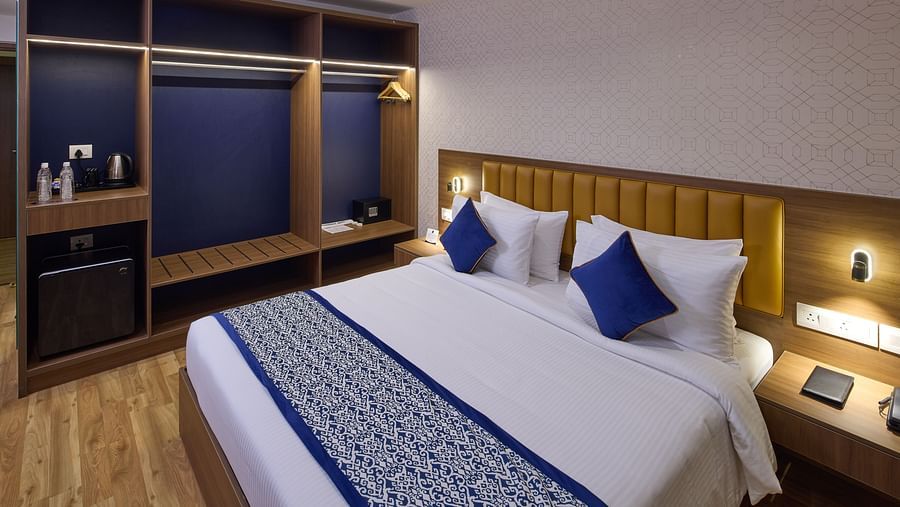 An inviting hotel room in Bengaluru with a plush king size bed, bedside lamps, an electric kettle and soft, ambient lighting - Grand Continent, Brookefield