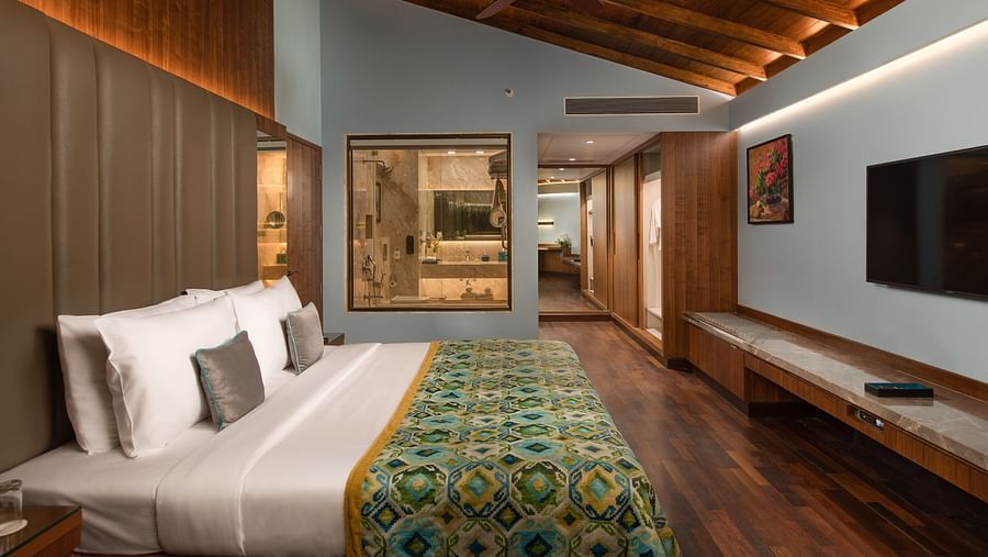 The Sea View Suite King Bed looks welcoming and grand placed amidst the blue walls and lovely wooden furnsishing