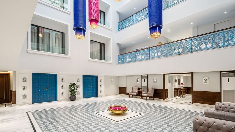 An image of our lobby with vibrant hanging lanterns and intricate blue railings - MJ Sarovar Portico, Haridwar